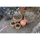 A quantity of terracotta planters; three matching
