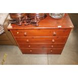 A stained pine four drawer chest