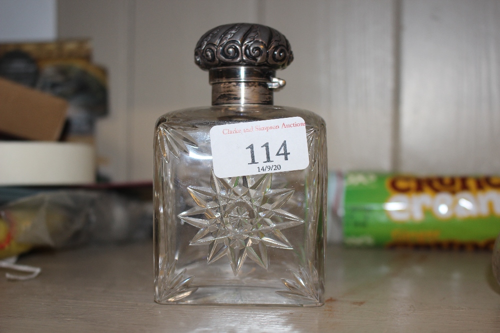 A square cut glass scent bottle with silver mounts