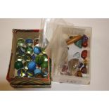 A box of various marbles; another box of stones an