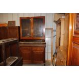 A late Victorian glazed cabinet raised on cupboard