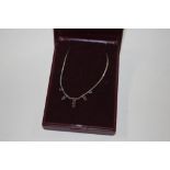 A silver and garnet set necklace