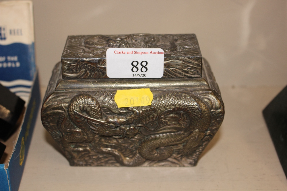 An oriental metal embossed box and cover with drag
