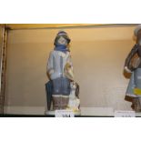 A Lladro porcelain figurine of a young boy with a