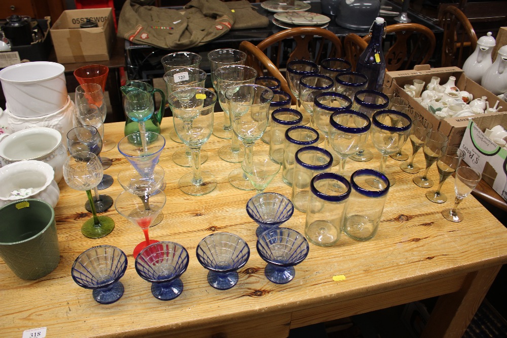 A quantity of various drinking glasses, blue glass