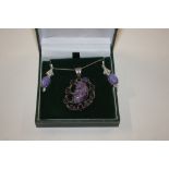 A silver and amethyst set pendant hung to a fine l