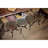 Four cast iron stools with lion mask decoration