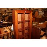 An oak veneered bookcase of narrow proportions