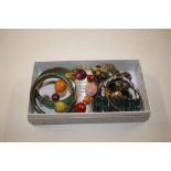 A box containing various faux Malachite bangles an