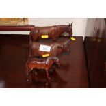 A carved wooden donkey, cow and horse