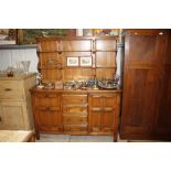 An Ercol elm sideboard fitted four drawers below