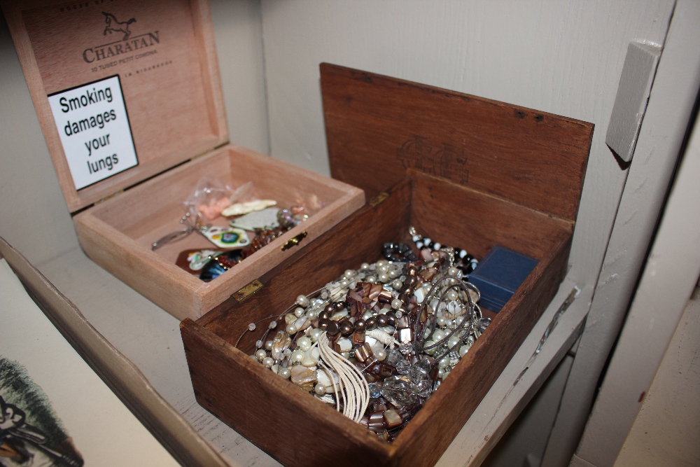A box containing various enamel and other brooches