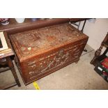 A Chinese camphor wood blanket box carved in relie