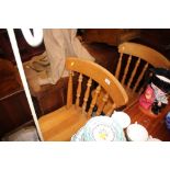 A pair of beech spindle back kitchen chairs