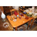 A modern pine kitchen table with two spindle back