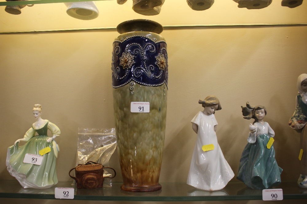 A tall Royal Doulton stoneware vase with floral de