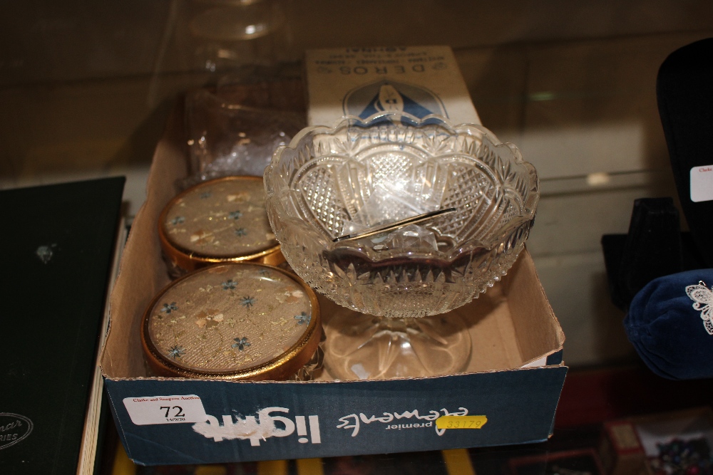 A box containing a glass pedestal bowl, jar and cov