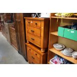 A pair of bedside chests fitted with three drawers