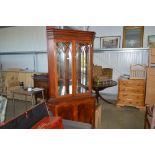 A reproduction yew wood corner cabinet