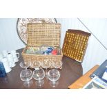 A basket of various glassware and boxed paperweigh