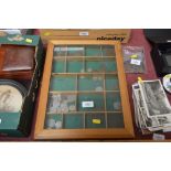 A display case and contents of various coinage