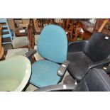 A green upholstered swivel office chair