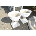 A pair of concrete garden urns