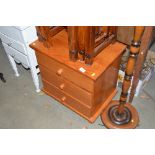 A modern pine bedside chest fitted three drawers