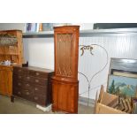 A reproduction yew wood corner cabinet