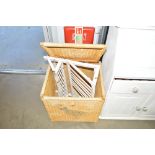 A wicker linen basket; and a vintage plate rack