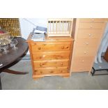 A modern pine chest fitted fur long drawers