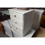 A bedside chest fitted three drawers