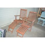 A pair of teak steamer chairs