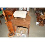 A upholstered foot stool and a teak sewing machine