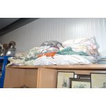 Four bundles of various towels and bed linen