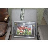 A framed and glazed Manchester United print and a