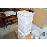 A pair of white painted bedside chests fitted two