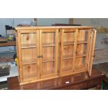 A pair of small pine glazed cabinets