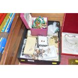A box containing various costume jewellery and whi