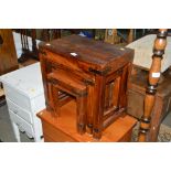 A nest of three hardwood occasional tables