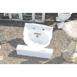 A white glazed sink and pedestal