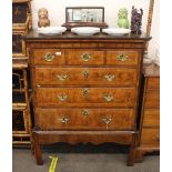 A 18th Century walnut chest on stand, fitted three short and three long drawers, the base raised