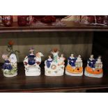 A collection of five various Staffordshire figures and spill vases, some AF