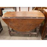 An 18th Century oak gate leg dining table, fitted single end drawer raised on turned baluster