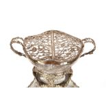 A cut glass and silver mounted twin handled bowl, having finely etched decoration, foliate pierced