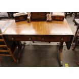 A 19th Century mahogany and ebony strung sofa table, raised on end supports terminating in sabre