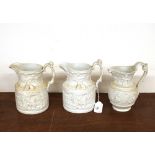 A pair of Masons ironstone white relief moulded jugs, having figural and mask head decoration; and a
