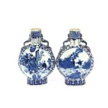 A pair of 19th Century Chinese blue and white moon flasks, having figural decoration flanked by
