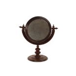 A 19th Century mahogany swing toilet mirror, raised on a turned column and circular spread foot,
