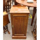 An Edwardian mahogany bedside cupboard, enclosed by a single panelled door